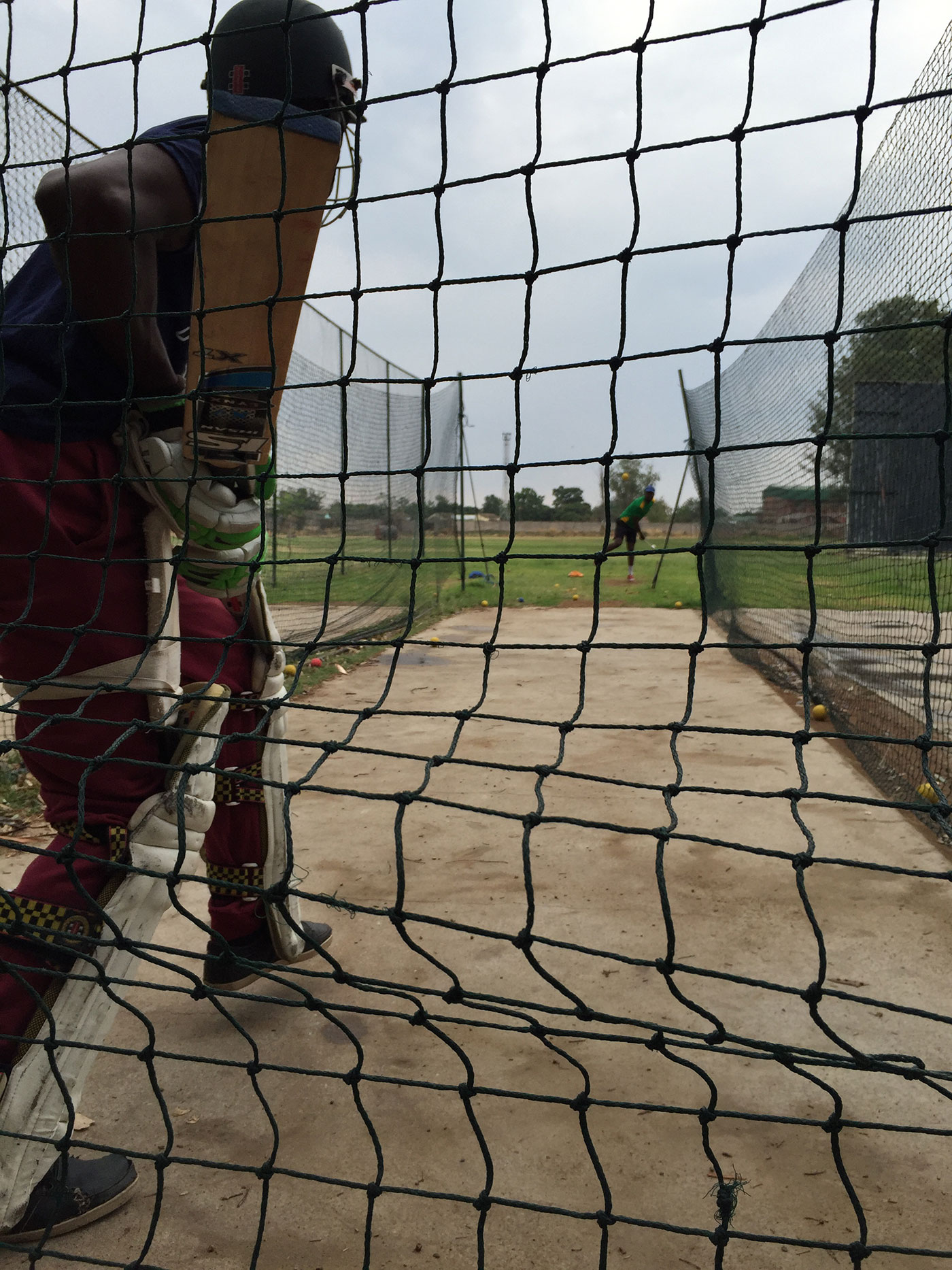 A batsman receives throwdowns at Takashinga