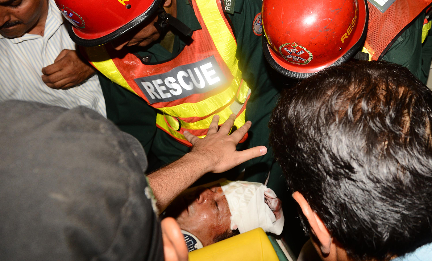 An injured Imran is taken to hospital after he fell off a makeshift elevator during an election rally in Lahore in 2013