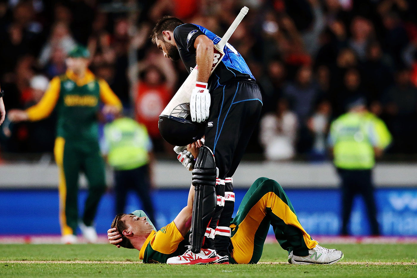 Gracious in victory: Grant Elliott helps Dale Steyn up after New Zealand won a thrilling game to qualify for their first World Cup win