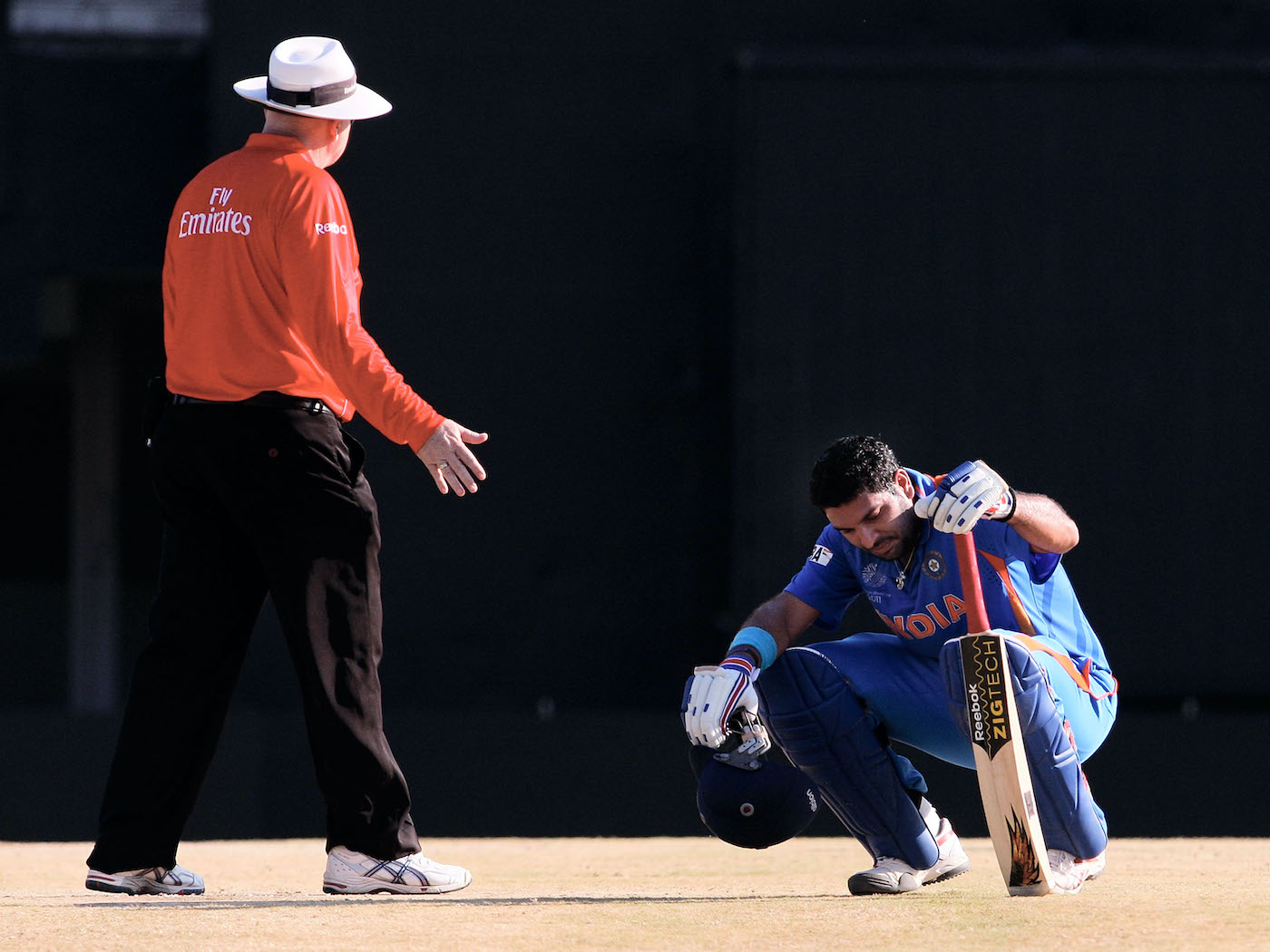 Umpire Steve Davis checks on a dehydrated and heat-exhausted Yuvraj Singh during India's game against West Indies in Chennai