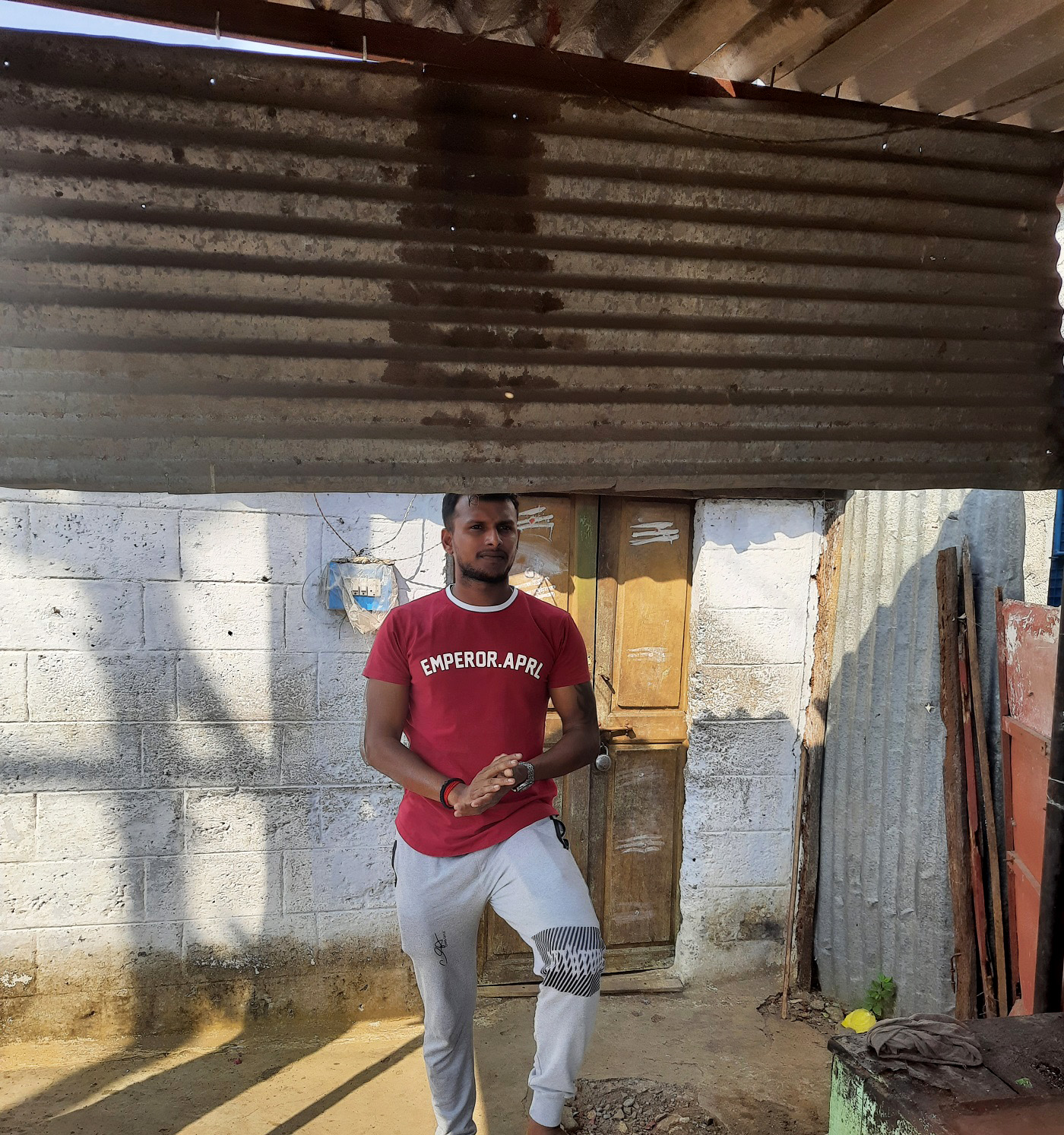 Where it all began: Natarajan stands outside his old one-room house