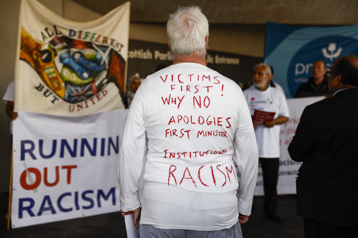 An activist at a rally outside the Scottish Parliament ahead of a debate in the chamber on the issue of racism in sport