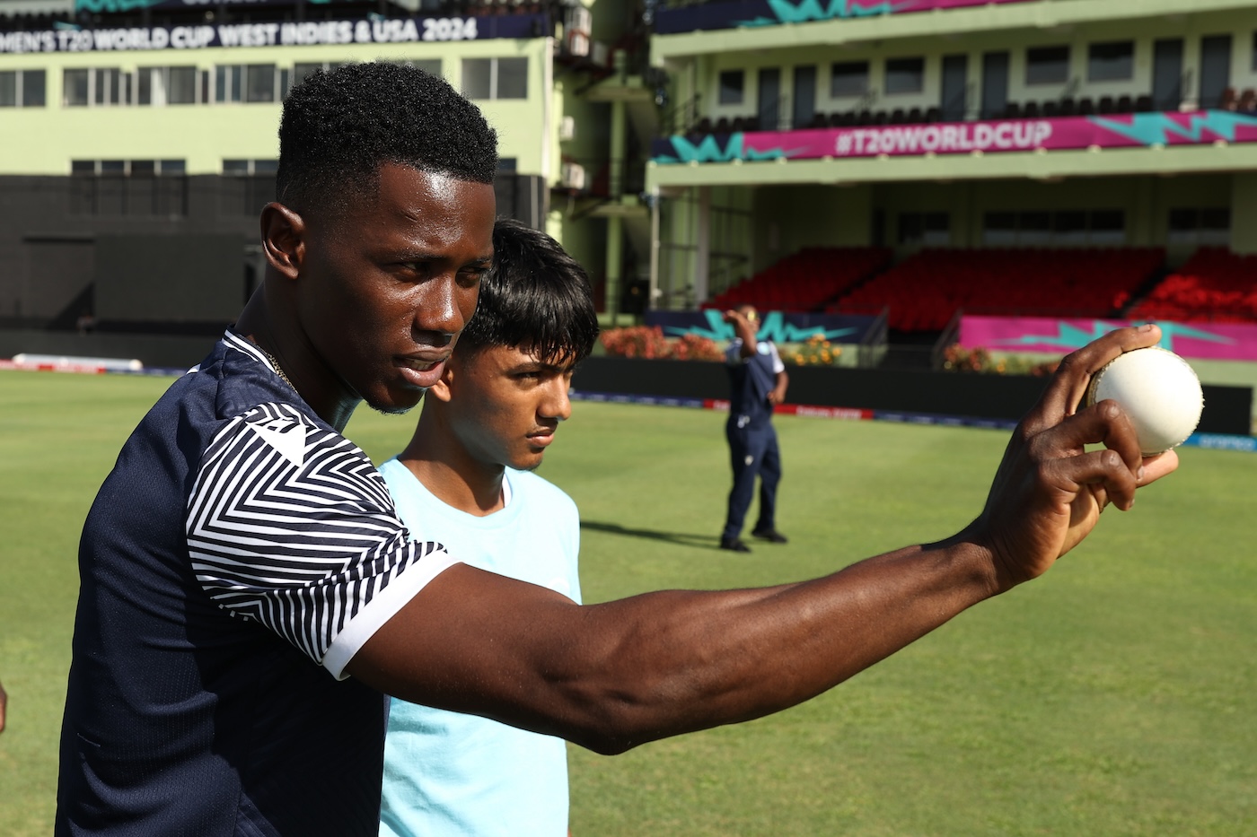 Pay it forward: Joseph gives a youngster tips at the West Indies Cricket 4 Good clinic in Georgetown during this year's T20 World Cup