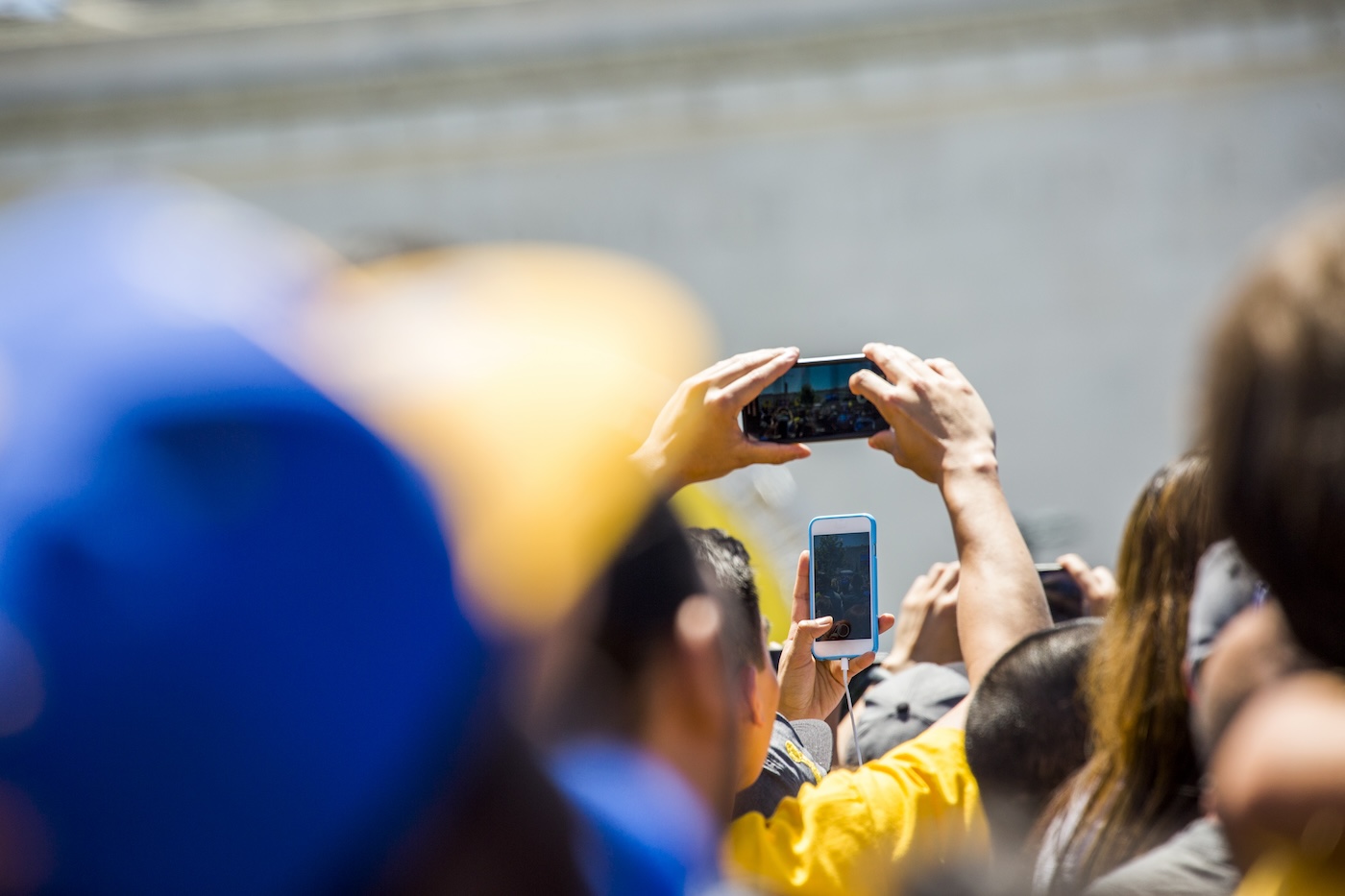 A group of people, some with their phones held up 
