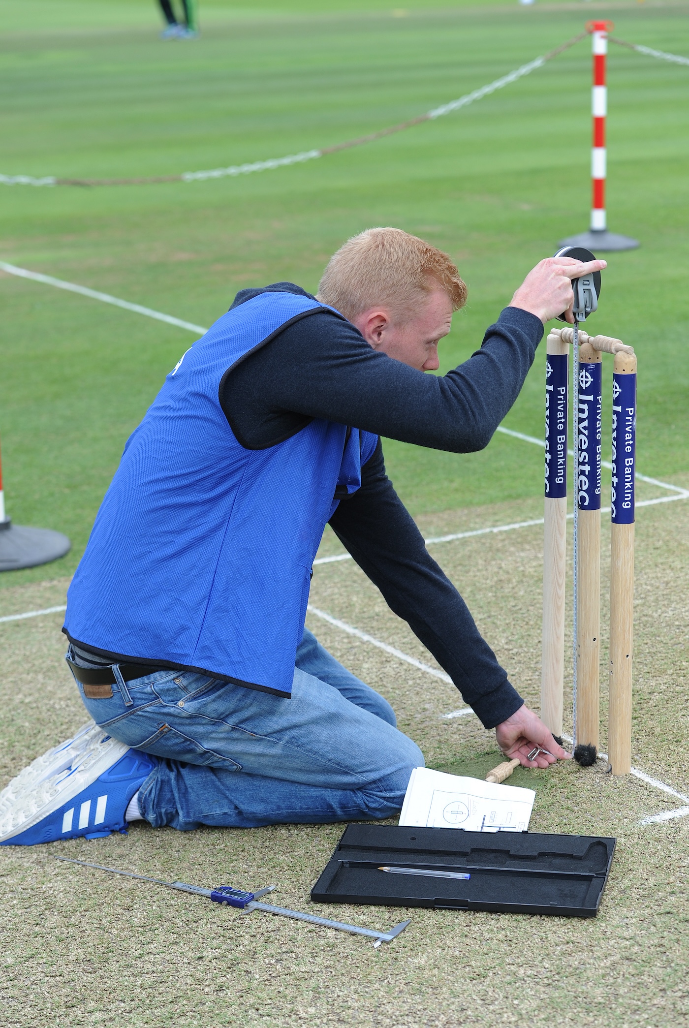 A Hawk-Eye technician measures the stumps