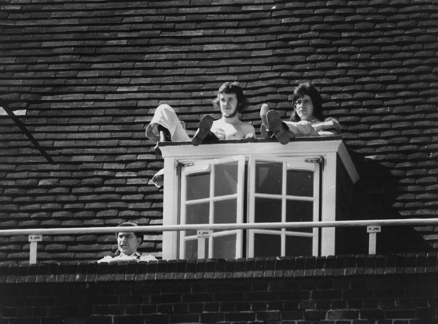 When the going gets rough, the roof gets going: striking workers watch a match at The Oval from a unique vantage point