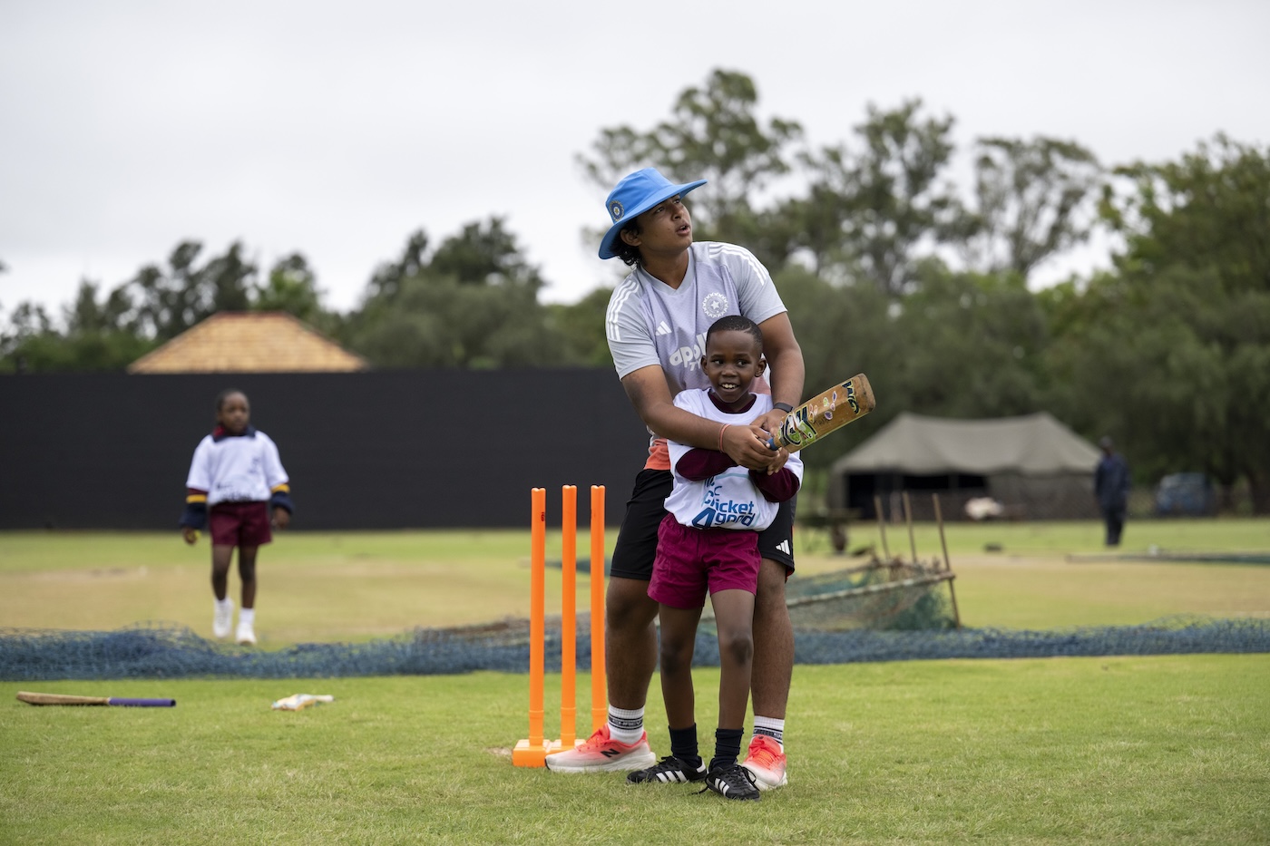 Here's the manual, now tear it up: Sooryavanshi coaches a local child at the India Cricket4Good clinic in Bulawayo during this year's U19 World Cup